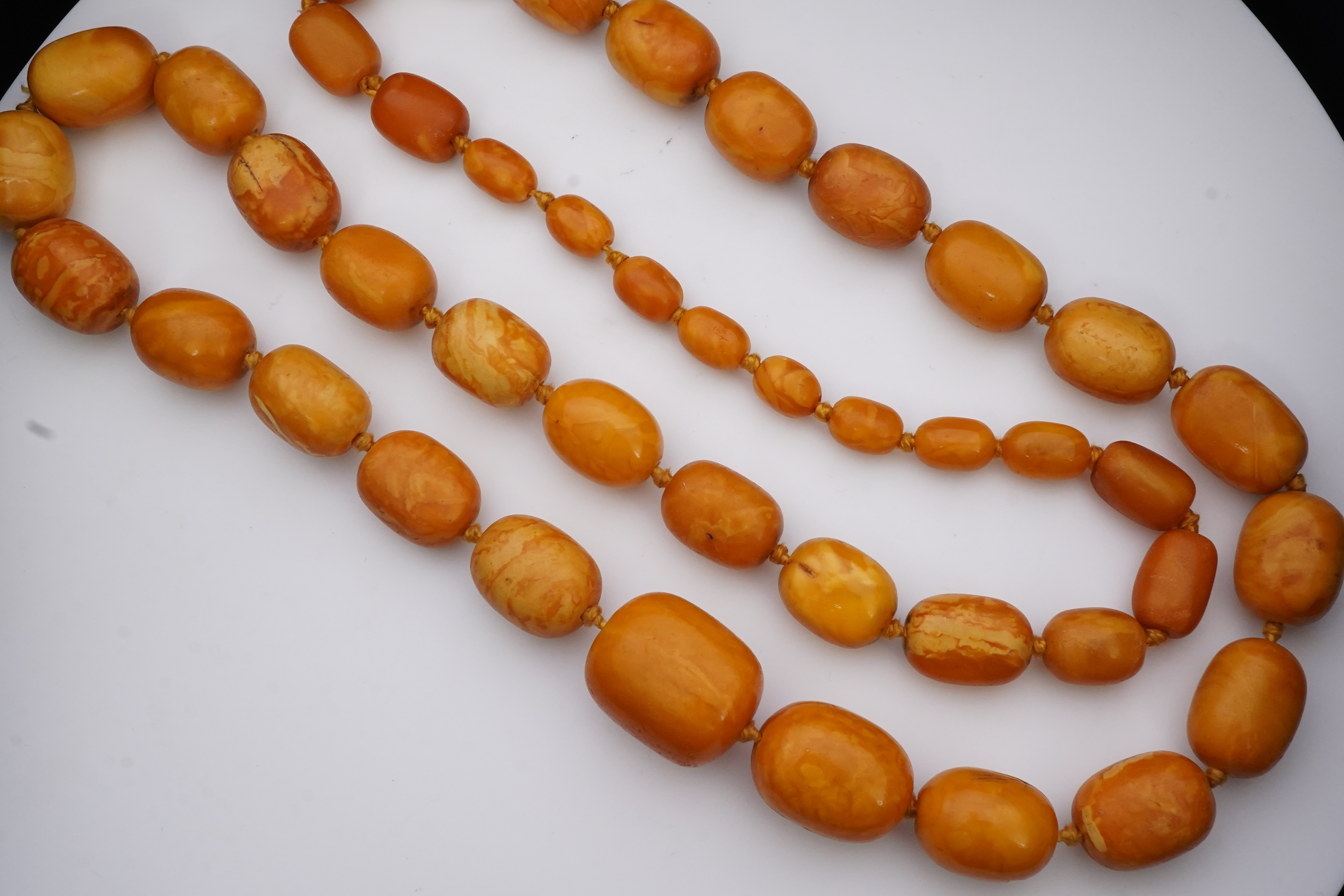 A single strand graduated oval amber bead necklace